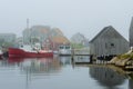 Red Boats in Foggy Harbor with Fishing Shack Royalty Free Stock Photo