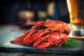 Red boiled crayfish with lemon and herbs on stone slate