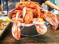 Red boiled Lobsters in a metal basin Royalty Free Stock Photo