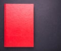 Red book with blank empty cover on black stone table background Royalty Free Stock Photo