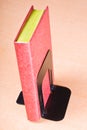 Red book leaning on bookend Royalty Free Stock Photo