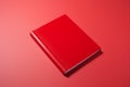 Red book positioned on a red background, achieving a harmonious and bold aesthetic, perfect for projects seeking a cohesive and