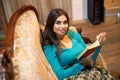 With red book is woman on sofa Royalty Free Stock Photo