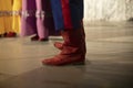 Red boots on Cossack. Traditional footwear. Folklore ensemble on stage