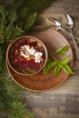 Red borscht made of beetrot, vegetables and meat with sour cream on a wooden background, vertical image top view Royalty Free Stock Photo