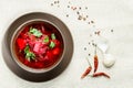 Red borscht soup in brown bowl top view, on white tablecloth. Royalty Free Stock Photo