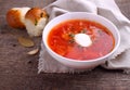 Red borscht soup in white bowl with sour cream Royalty Free Stock Photo