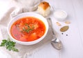 Red borscht soup in white bowl with sour cream and parsley Royalty Free Stock Photo