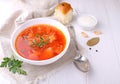 Red borscht soup in white bowl with sour cream and parsley, top view Royalty Free Stock Photo