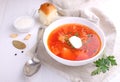 Red borscht soup in white bowl with sour cream and parsley, top view Royalty Free Stock Photo