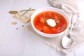 Red borscht soup in white bowl with sour cream Royalty Free Stock Photo