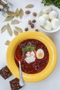 Red borscht soup in yellow plate from top Royalty Free Stock Photo