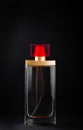 Red bottle with perfume or cologne on black background. Royalty Free Stock Photo