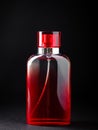 Red bottle with perfume or cologne on black background. Royalty Free Stock Photo