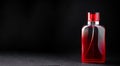 Red bottle with perfume or cologne on black Royalty Free Stock Photo