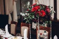 Red bouquet in vase on table at wedding luxury reception in rest
