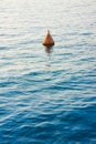 Red bouy on a calm lake - concept image with copy space Royalty Free Stock Photo