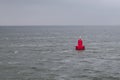 Red bouy floating in sea