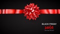 Red bow with horizontal ribbon with shadow and inscription Black Friday Sale Royalty Free Stock Photo