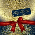 Red bow and new year greeting card on a gold glittery background