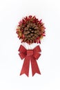 Red bow with pinecone flower over tinsel christmas decoration isolated. Xmas Royalty Free Stock Photo
