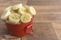 Red bowl with banana slices on white background Royalty Free Stock Photo