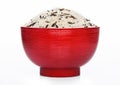 Red bowl of raw organic basmati long grain and wild rice on white background. Healthy food Royalty Free Stock Photo