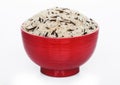 Red bowl of raw organic basmati long grain and wild rice on white background. Healthy food Royalty Free Stock Photo