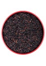 Red bowl of raw organic black venus rice on white background. Healthy food Royalty Free Stock Photo