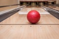 Red bowling ball on the track in the bowling center Royalty Free Stock Photo