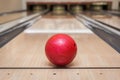 Red bowling ball on the track in the bowling center Royalty Free Stock Photo