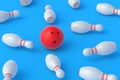 Red bowling ball and white pins on blue background Royalty Free Stock Photo