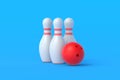 Red bowling ball and white pins on blue background Royalty Free Stock Photo