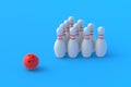 Red bowling ball and white pins in form of triangle on blue background Royalty Free Stock Photo