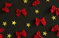 Red bows and yellow gold stars on black background