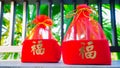 Red box gift box in Chinese New Year. Chinese character is `fu` means Luck and good fortune. Chinese New Year, elders always hav