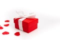 A red box with a gift in small red hearts on a white background, a template for Valentines day with a copy space, a Royalty Free Stock Photo