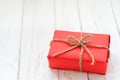 Red box gift on white wooden table Royalty Free Stock Photo
