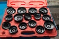 Red Box with a set of removable caps for oil filters of different sizes and diameters for the safe removal of old parts in a Royalty Free Stock Photo