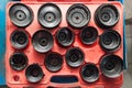 Red Box with a set of removable caps for oil filters of different sizes and diameters for the safe removal of old parts in a Royalty Free Stock Photo