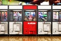 Red box stands out among toys vending machines with crane. 3D illustration