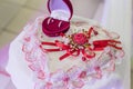 Red box with wedding rings lies on white table in shape of a heart. Royalty Free Stock Photo