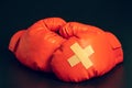 Red boxing gloves in the dark background. Adhesive plaster across each other on boxing gloves. Royalty Free Stock Photo