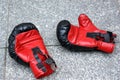 Red boxing gloves lying on the street Royalty Free Stock Photo