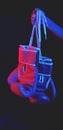 Red boxing gloves, ring with red and blue lights, industrial gym. selective focus