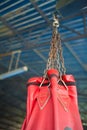 Red Boxing sand bags hanging at gym.