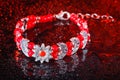 Red bracelet with drops of water Royalty Free Stock Photo
