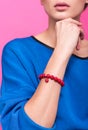 Red bracelet made of beads on the arm of a young woman. Handmade accessories Royalty Free Stock Photo