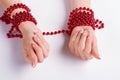 Red bracelets with beads on the female hands. Royalty Free Stock Photo