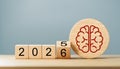 Red Brain Icon on Wooden Round Block with 2025 Changing to 2026 Cubes Royalty Free Stock Photo